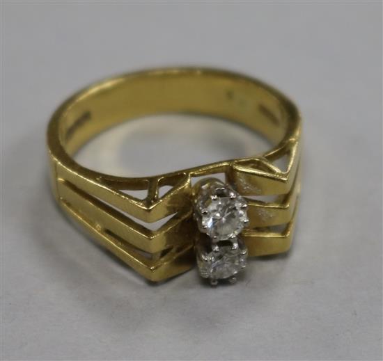 An 18ct gold and two stone diamond dress ring, size O.